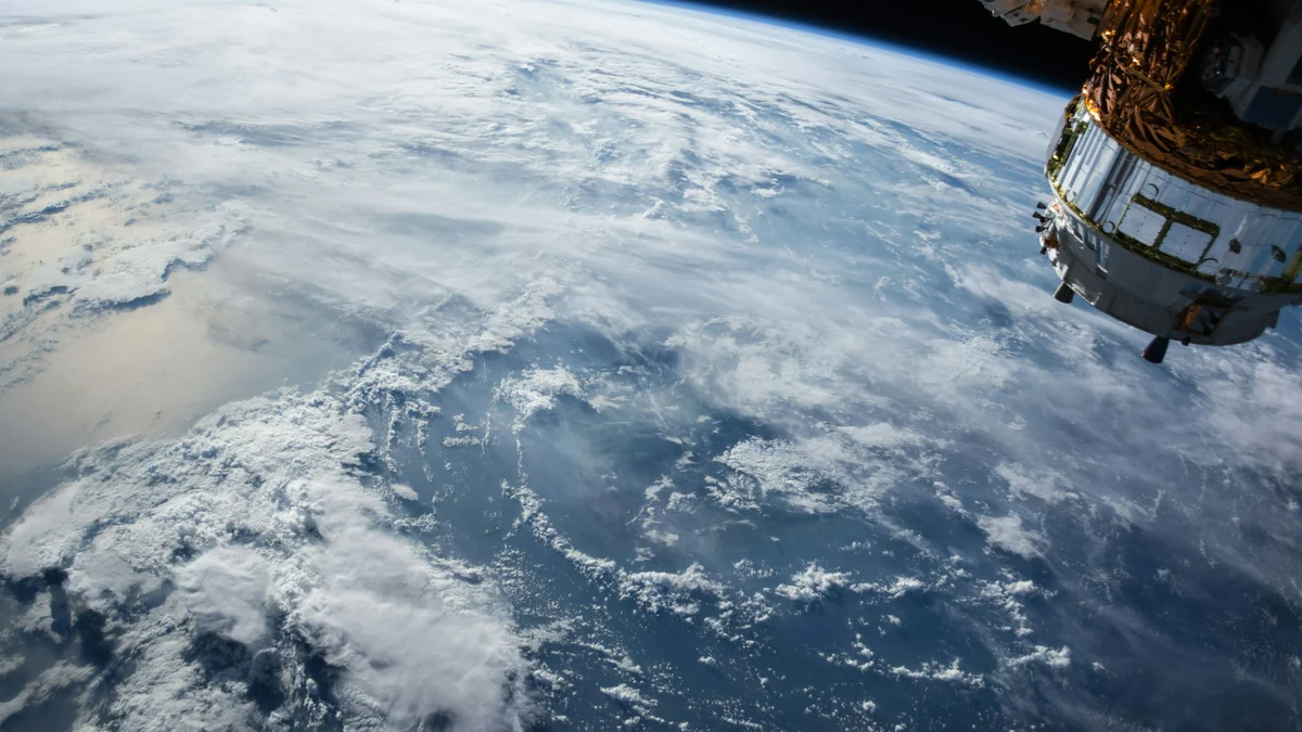 Vista de satélite da Terra a partir da órbita, com um extenso campo de nuvens brancas sobre o oceano azul — o tipo de dado que alimenta um modelo de previsão do tempo